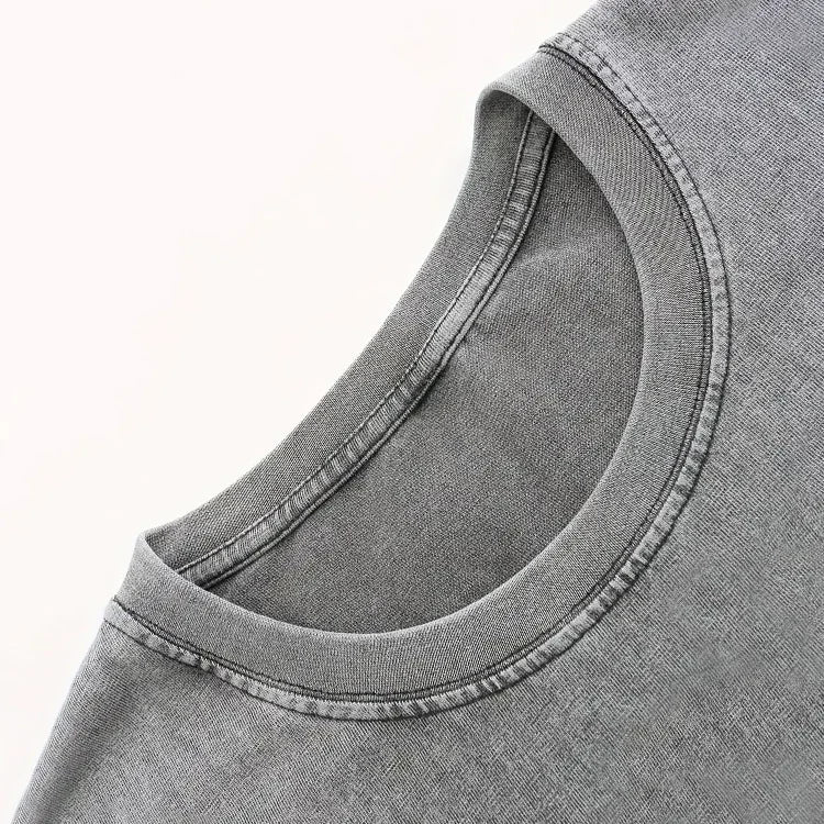 Close up of a grey crew neck t-shirt collar with visible stitching detail