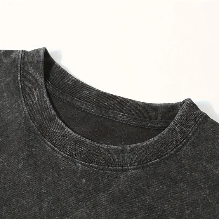 Close-up of black acid wash crew neck t-shirt collar on white background