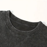 Close-up of black acid wash crew neck t-shirt collar on white background