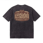 Black t-shirt with Western desert graphic and 'Rough It Out' text on the back.